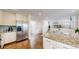 Spacious kitchen featuring stainless steel refrigerator, a breakfast bar, and hardwood floors throughout at 11427 King Way, Westminster, CO 80031