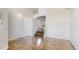 Spacious living room with beautiful hardwood floors and stairs leading to the second floor at 11427 King Way, Westminster, CO 80031