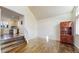 Spacious living room with hardwood floors and staircase leading to kitchen at 11427 King Way, Westminster, CO 80031