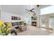 Cozy living room with fireplace, vaulted ceilings, ceiling fan, and an outdoor patio entrance at 11427 King Way, Westminster, CO 80031
