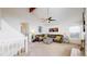 Vaulted ceiling living room featuring a ceiling fan, carpeted floors, and a stairway to the upper level at 11427 King Way, Westminster, CO 80031