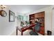 Home office space featuring a wood desk, built-in shelving and a pair of windows at 11427 King Way, Westminster, CO 80031