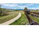 Scenic view of a neighborhood walking path with lush surroundings and mountain views in the distance at 11427 King Way, Westminster, CO 80031