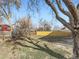 Spacious backyard is enclosed by a mix of wood and wire fencing with mature trees at 5153 Scranton St, Denver, CO 80239