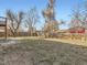 Large backyard with minimal grass is surrounded by wood fencing at 5153 Scranton St, Denver, CO 80239