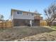 Backyard showing two-story home with brick and siding, leading to a wooden deck at 5153 Scranton St, Denver, CO 80239