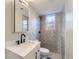 Modern bathroom with tiled walls, bright lighting, sleek fixtures, and a modern vanity at 5153 Scranton St, Denver, CO 80239