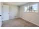 Comfortable carpeted bedroom features a large window offering a lovely view of the landscape at 5153 Scranton St, Denver, CO 80239