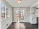 Sun-filled dining area featuring hardwood floors and French doors leading to a deck, perfect for entertaining guests at 5153 Scranton St, Denver, CO 80239