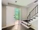 Inviting entryway features a textured glass window for privacy and a staircase with modern black railings at 5153 Scranton St, Denver, CO 80239