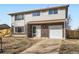 Charming two-story home featuring brick accents, white trim, and a well-maintained front yard with attached garage at 5153 Scranton St, Denver, CO 80239