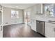 Bright kitchen connects to an eating area with hardwood flooring and French doors leading to an outdoor space at 5153 Scranton St, Denver, CO 80239