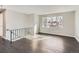 Open-concept living room featuring large windows, providing ample natural light, and sleek hardwood flooring at 5153 Scranton St, Denver, CO 80239