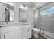 Bathroom showcasing double sink vanity, modern lighting, and a glass-enclosed shower at 2140 S Ash St # 105, Denver, CO 80222