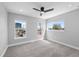 Spacious bedroom with plush carpeting, modern ceiling fan, and sun-filled windows at 2140 S Ash St # 105, Denver, CO 80222