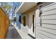 Modern townhouse exterior featuring a white front door, house number 1049, and sleek design at 2140 S Ash St # 105, Denver, CO 80222