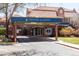 An inviting welcome area is shown outside Denver Academy, featuring a covered entrance and well-maintained landscaping at 2140 S Ash St # 105, Denver, CO 80222