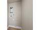 Neutral colored laundry room showcasing hookups and available outlets ready for washer and dryer installation at 2140 S Ash St # 105, Denver, CO 80222