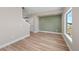 Comfortable living room featuring wood floors, decorative green wall, and natural light at 2140 S Ash St # 105, Denver, CO 80222