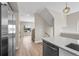 Open floor plan with kitchen island, stairway, and large window bringing in natural light at 2140 S Ash St # 105, Denver, CO 80222