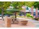 Attractive outdoor seating area with green umbrellas and landscaping, next to a brick building at 2140 S Ash St # 105, Denver, CO 80222