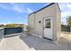 Outdoor rooftop deck with tiled floor featuring an air conditioning unit and building access door at 2140 S Ash St # 105, Denver, CO 80222