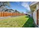 Lush green backyard with a wooden fence and retaining wall providing privacy at 3561 W 131St Ave, Broomfield, CO 80020
