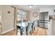 Bright dining area with view of landscaped yard and adjacent stainless refrigerator at 3561 W 131St Ave, Broomfield, CO 80020