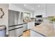 Modern kitchen boasts stainless appliances, granite counters, and bright white cabinets at 3561 W 131St Ave, Broomfield, CO 80020