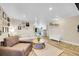 Open-concept living room with hardwood floors and warm tones with neutral color sofa at 3561 W 131St Ave, Broomfield, CO 80020