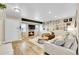 Bright living room with a stone fireplace, TV, and hardwood floors that accent the space at 3561 W 131St Ave, Broomfield, CO 80020