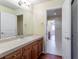 Bathroom features a large vanity, a sink, and a door leading into another room at 14033 E Whitaker Dr, Aurora, CO 80015