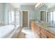 Bathroom featuring a soaking tub, a double sink vanity, and a glass-enclosed shower at 14033 E Whitaker Dr, Aurora, CO 80015