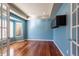 Stylish bedroom featuring recessed lighting, hardwood floors, and bright blue walls at 14033 E Whitaker Dr, Aurora, CO 80015