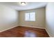 Neutral bedroom featuring hardwood floors, a window, and neutral paint, ready for personalization at 14033 E Whitaker Dr, Aurora, CO 80015