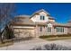 Charming home showcasing a two-car garage and stone exterior, complete with a tidy lawn at 14033 E Whitaker Dr, Aurora, CO 80015