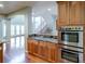 Gourmet kitchen featuring double ovens, granite countertops, and hardwood floors at 14033 E Whitaker Dr, Aurora, CO 80015