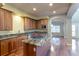 Bright kitchen with wooden cabinets, granite countertops, and stainless steel appliances at 14033 E Whitaker Dr, Aurora, CO 80015