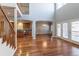 Open living area boasts hardwood floors, high ceilings, and views into the kitchen at 14033 E Whitaker Dr, Aurora, CO 80015