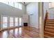 Expansive living room features hardwood floors, a fireplace, and access to an outdoor balcony at 14033 E Whitaker Dr, Aurora, CO 80015