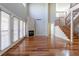 Bright living room featuring a fireplace, wood floors, and a staircase to the second story at 14033 E Whitaker Dr, Aurora, CO 80015