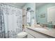 Bright bathroom featuring a shower with a decorative curtain, a vanity with a sink, and plenty of counter space at 14693 E Crestridge Dr, Aurora, CO 80015