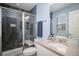 Modern bathroom featuring a glass-enclosed shower with dark gray tile, a light countertop, and blue walls at 14693 E Crestridge Dr, Aurora, CO 80015