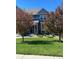 Lovely two-story home featuring mature trees in the front yard and a covered front porch at 14693 E Crestridge Dr, Aurora, CO 80015