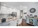 Modern kitchen showcasing white cabinets, stainless steel appliances, and an island with bar seating at 14693 E Crestridge Dr, Aurora, CO 80015