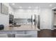 Well-lit kitchen featuring sleek countertops, stainless steel appliances, and modern white cabinetry at 14693 E Crestridge Dr, Aurora, CO 80015