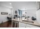 Open concept kitchen showcasing stainless steel dishwasher and sink, flowing to eating area and desk space at 14693 E Crestridge Dr, Aurora, CO 80015