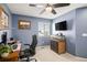 Functional home office with a spacious desk, ceiling fan, and large window for natural light at 14693 E Crestridge Dr, Aurora, CO 80015