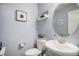 Charming powder room with modern fixtures, blue walls, and decorative accents at 14693 E Crestridge Dr, Aurora, CO 80015