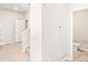 Hallway with an entrance to the bathroom, open doors, and light walls and floors at 781 N Tempe St, Aurora, CO 80018